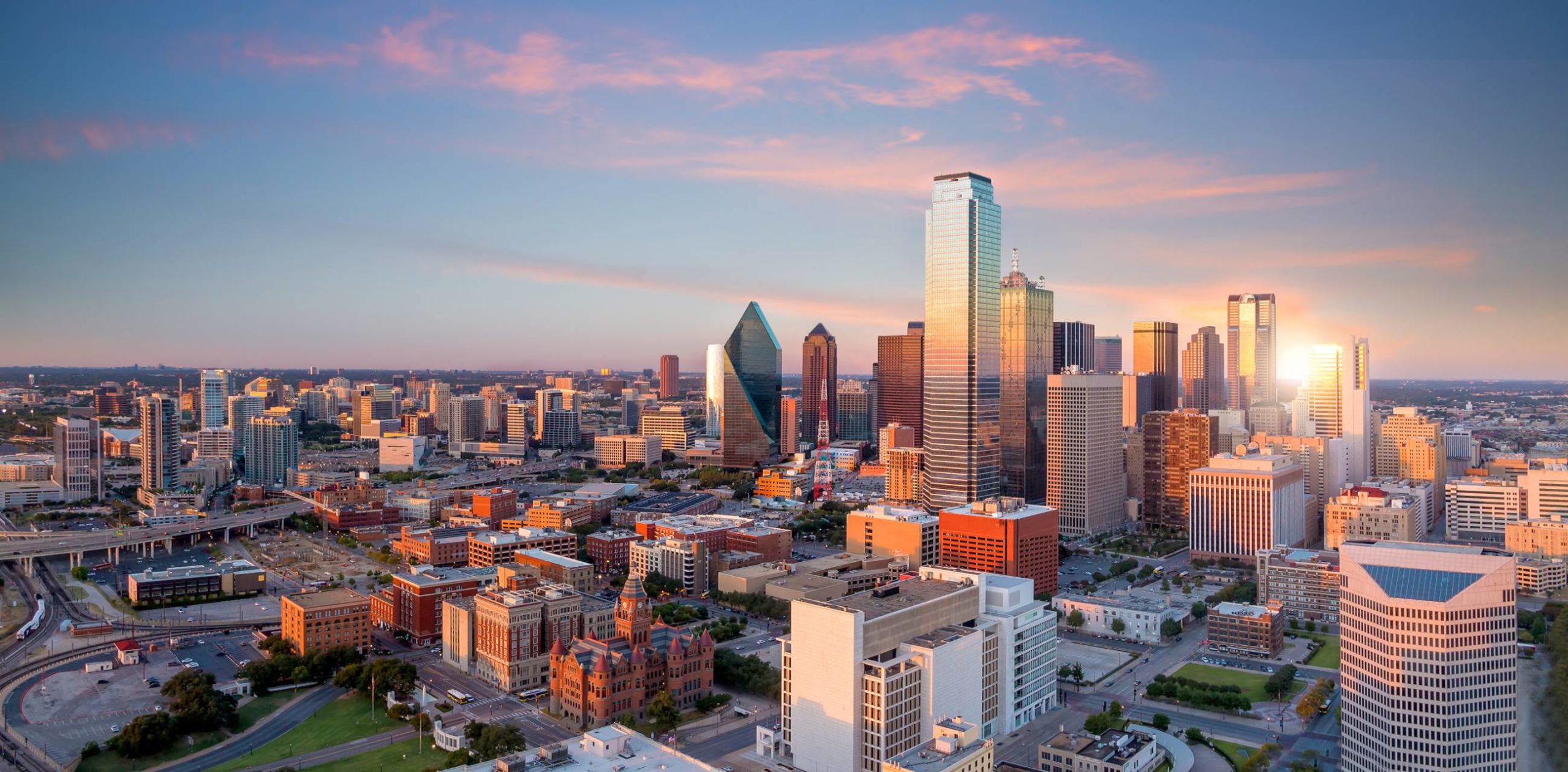 Dallas, Texas cityscape with blue sky at sunset in USA Dallas, Texas cityscape with blue sky at sunset in USA